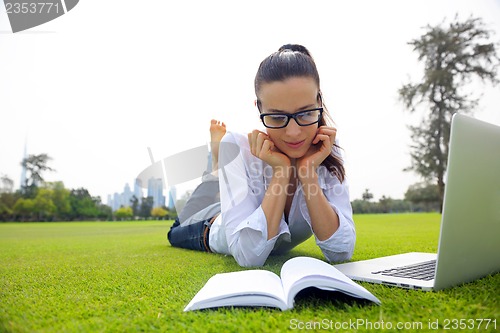 Image of woman with laptop in park