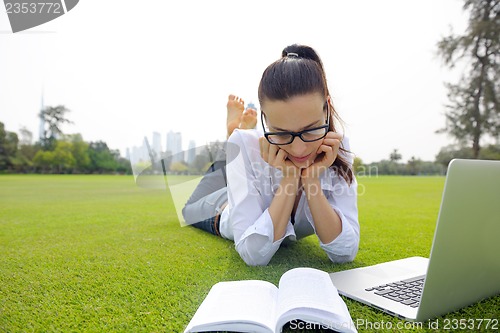 Image of woman with laptop in park