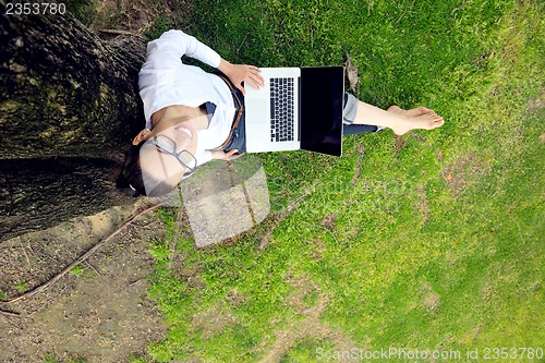 Image of woman with laptop in park