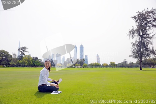 Image of woman with laptop in park