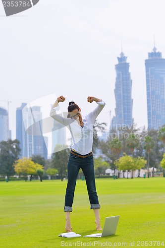Image of woman with laptop in park