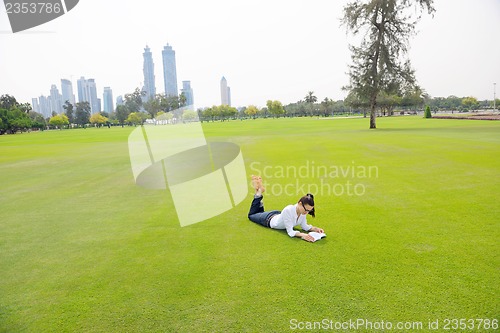 Image of woman with laptop in park