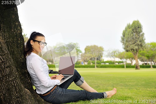 Image of woman with laptop in park