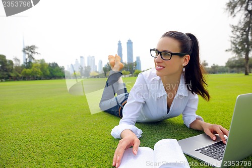 Image of woman with laptop in park