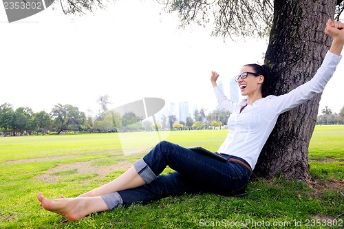 Image of Beautiful young woman with  tablet in park