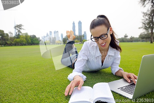 Image of woman with laptop in park