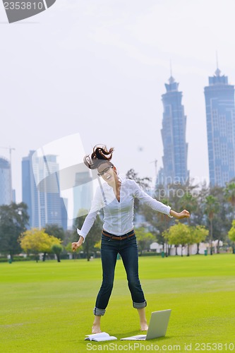 Image of woman with laptop in park