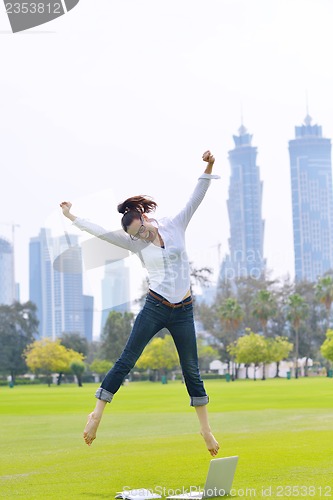Image of woman with laptop in park