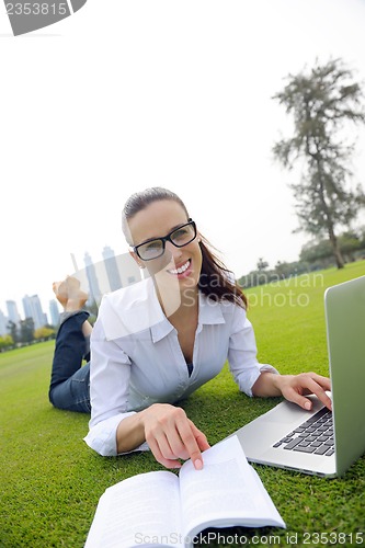 Image of woman with laptop in park