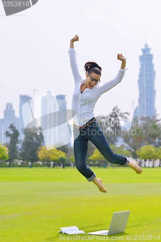 Image of woman with laptop in park