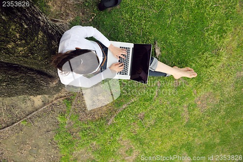 Image of woman with laptop in park