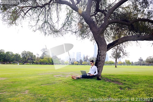 Image of woman with laptop in park