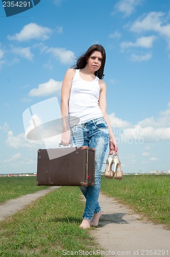 Image of Pretty woman with old suitcase