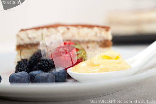 Image of tiramisu dessert with berries and cream