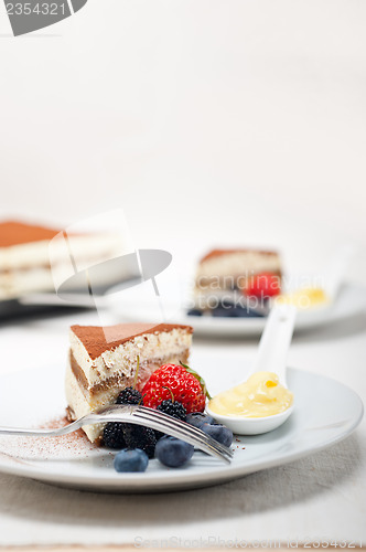 Image of tiramisu dessert with berries and cream