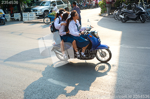 Image of Schoolgirls on motorbike