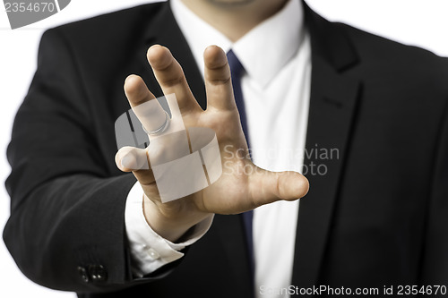 Image of Businessman in a suit holds out his hand