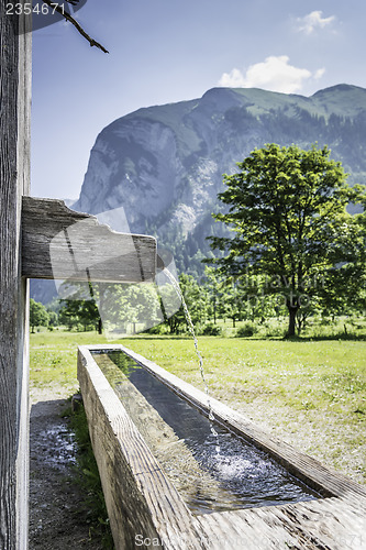 Image of Drink fountain in Alps with mountains