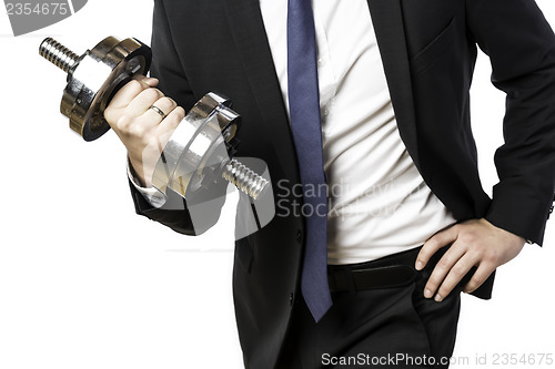 Image of Businessman holding silver dumbbell