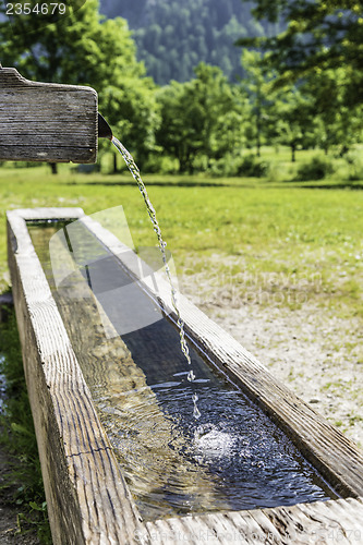 Image of Flowing drinking fountina in Alps