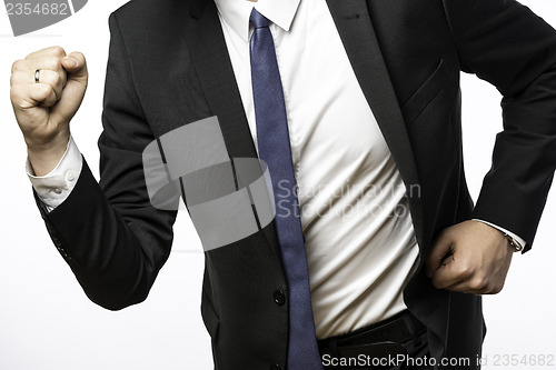 Image of Businessman on the move with clenched fists