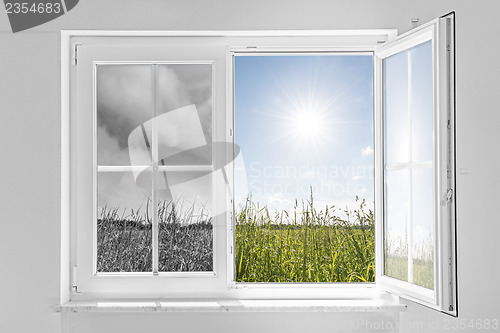 Image of window with storm and sun