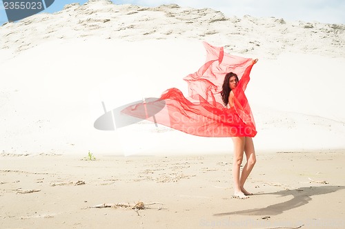 Image of Attractive naked girl on sand