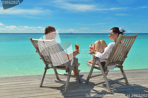 Image of happy young couple relax and take fresh drink