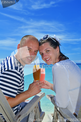 Image of happy young couple relax and take fresh drink