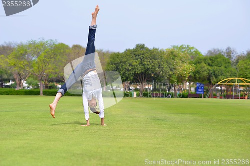 Image of young woman jumping in park