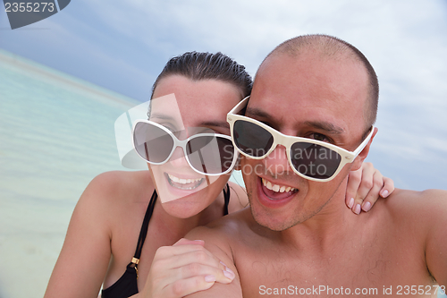 Image of happy young  couple at summer vacation have fun and relax at bea