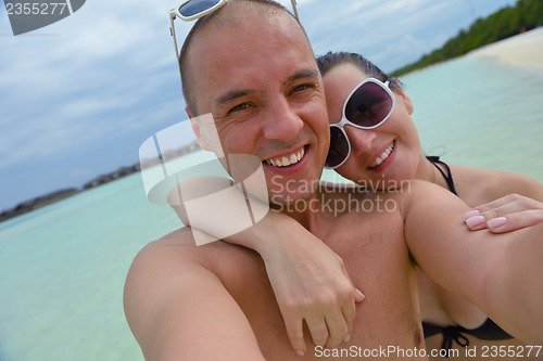 Image of happy young  couple at summer vacation have fun and relax at bea