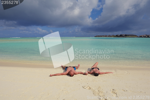 Image of happy young  couple at summer vacation have fun and relax at bea