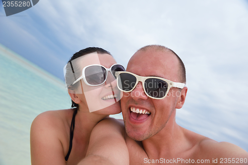 Image of happy young  couple at summer vacation have fun and relax at bea