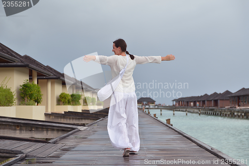 Image of young woman relax on cloudy summer day