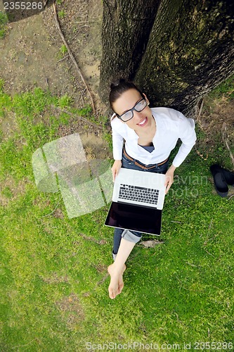 Image of woman with laptop in park