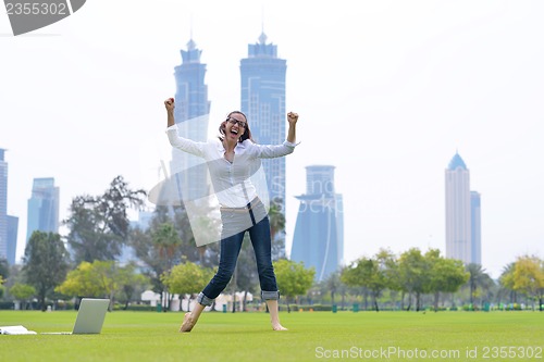 Image of woman with laptop in park