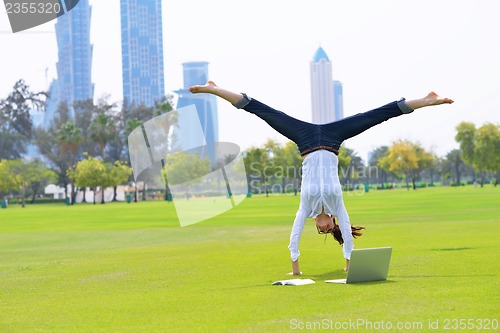 Image of woman with laptop in park