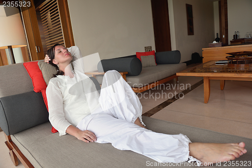 Image of happy young woman relax at home on sofa