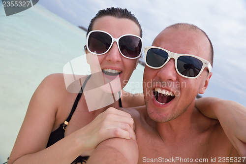 Image of happy young  couple at summer vacation have fun and relax at bea