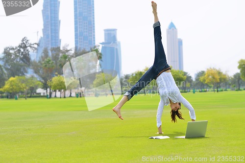 Image of woman with laptop in park