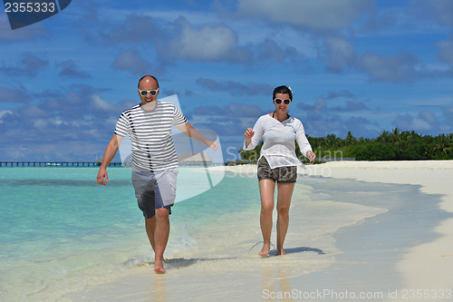 Image of happy young  couple at summer vacation have fun and relax at bea
