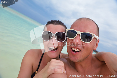 Image of happy young  couple at summer vacation have fun and relax at bea