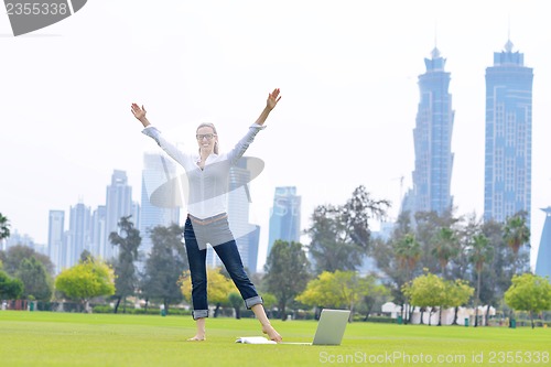 Image of woman with laptop in park