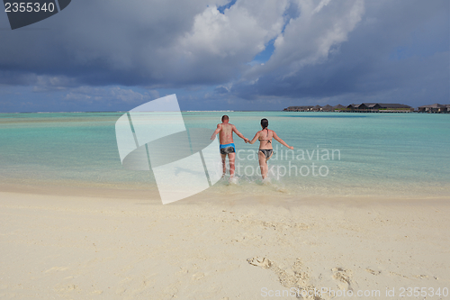 Image of happy young  couple at summer vacation have fun and relax at bea