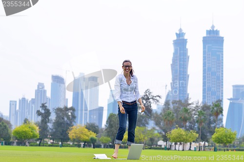 Image of woman with laptop in park