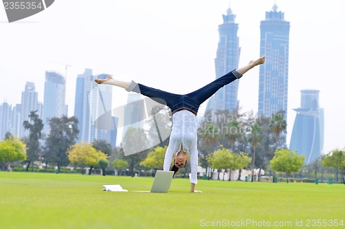 Image of woman with laptop in park