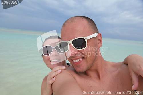 Image of happy young  couple at summer vacation have fun and relax at bea