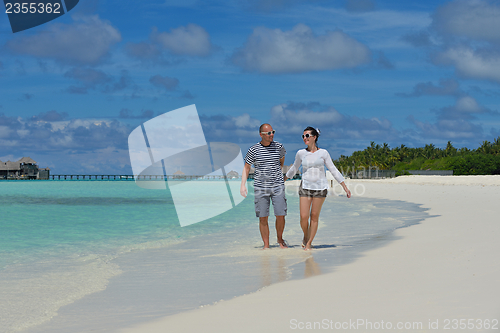 Image of happy young  couple at summer vacation have fun and relax at bea