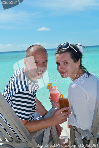 Image of happy young couple relax and take fresh drink